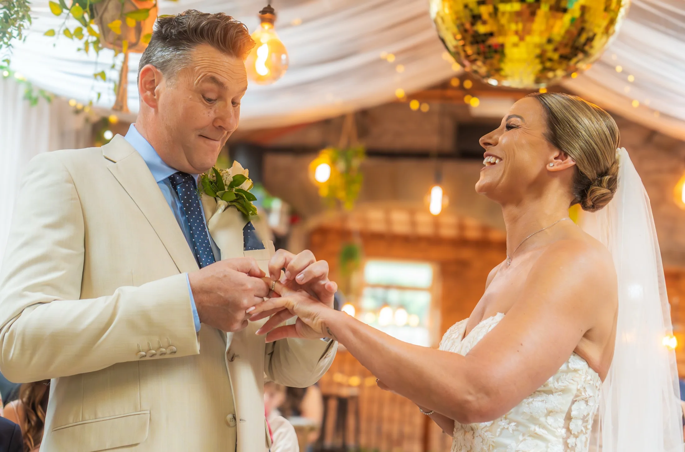 Marcus and Emma exchanging rings during their wedding ceremony