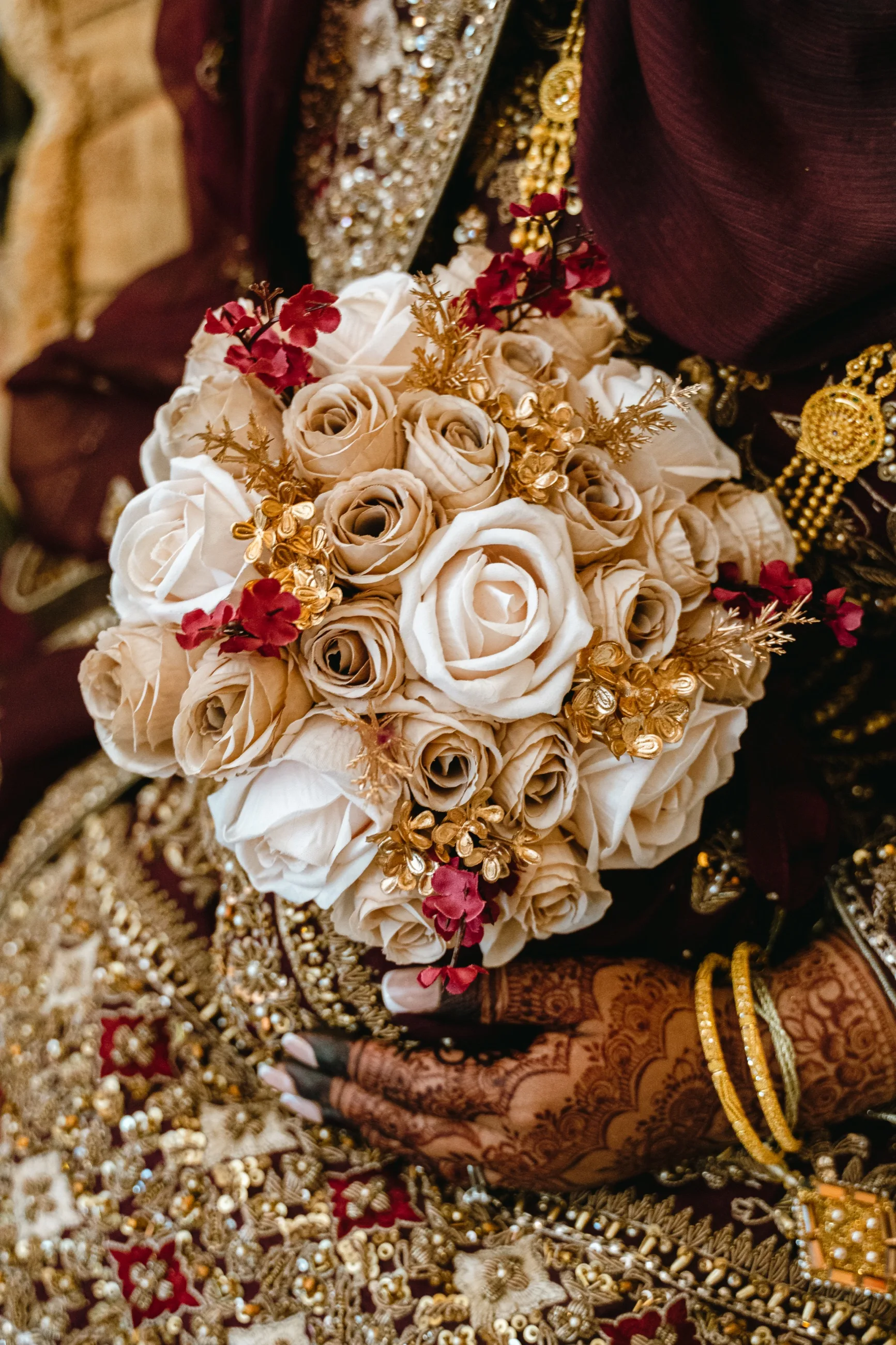 Bridal bouquet and gold bangles detail