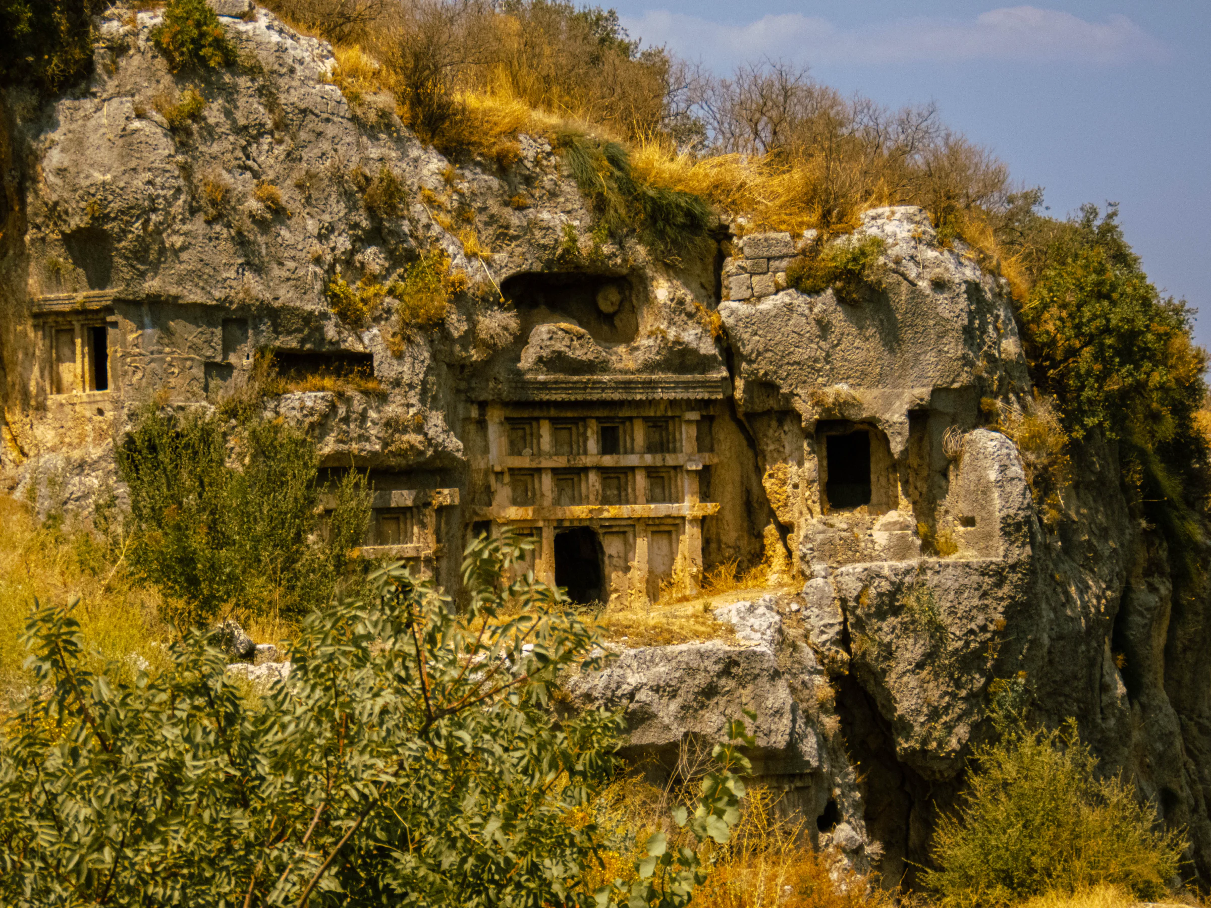 Lycian rock-cut tombs carved into a cliff face at Tlos in Türkiye