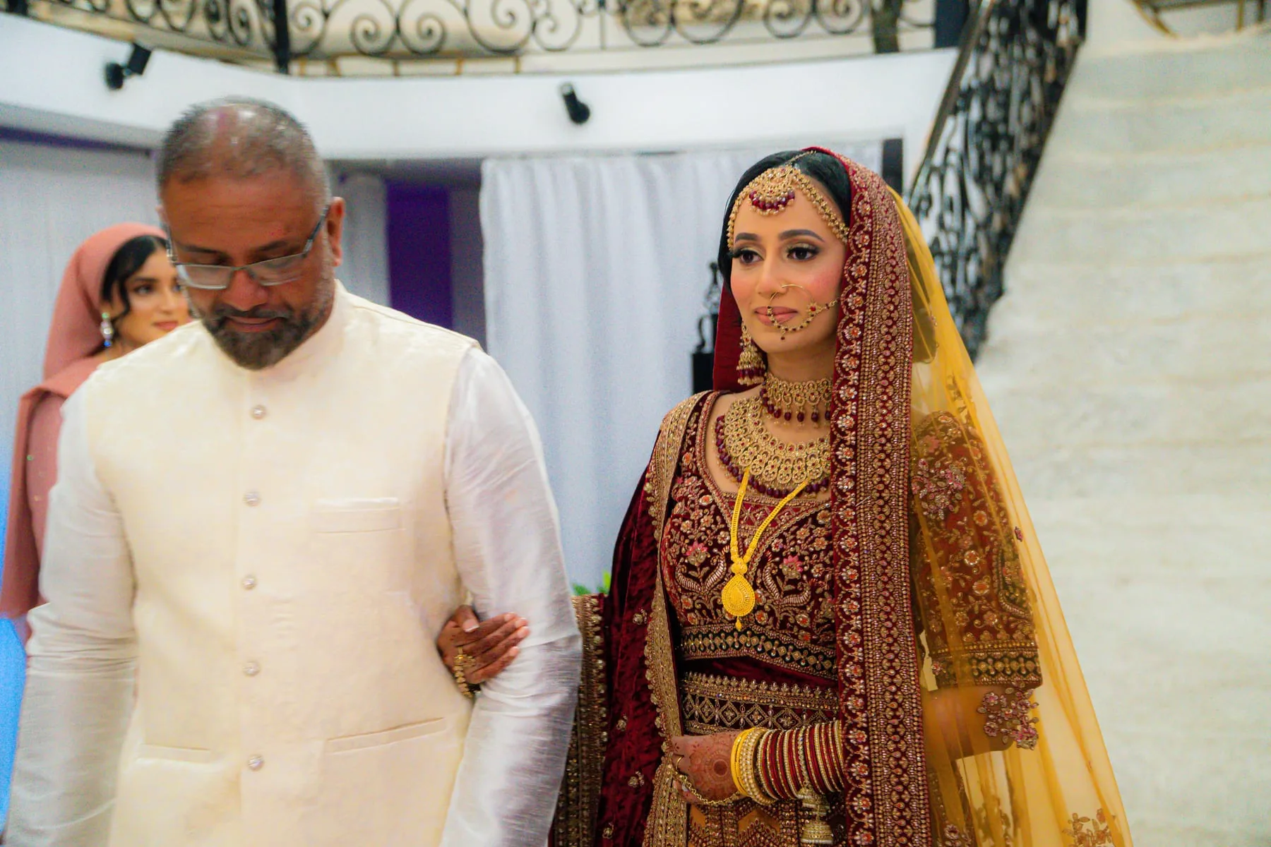 Bride entering the celebration with a family member