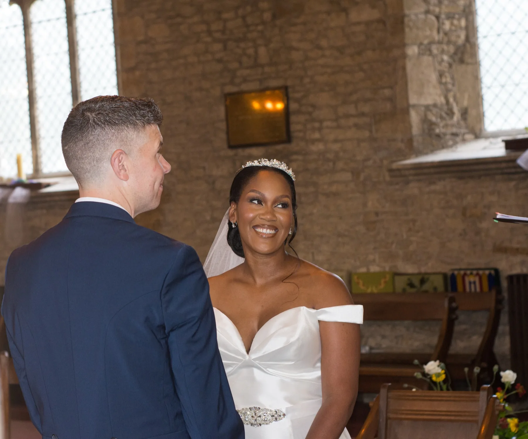 Bride smiling at the groom during their church ceremony