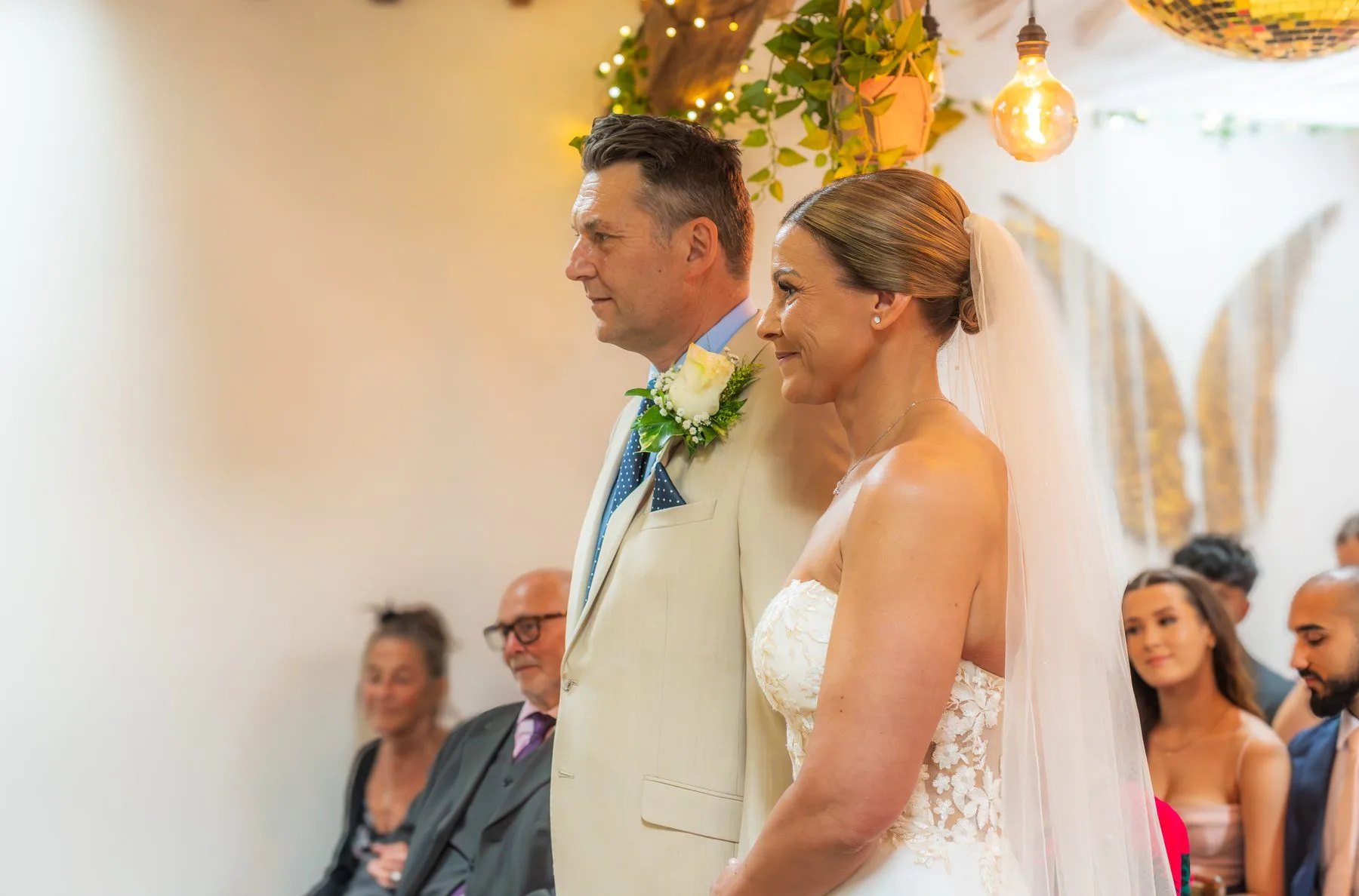 Marcus and Emma during their ceremony with guests watching